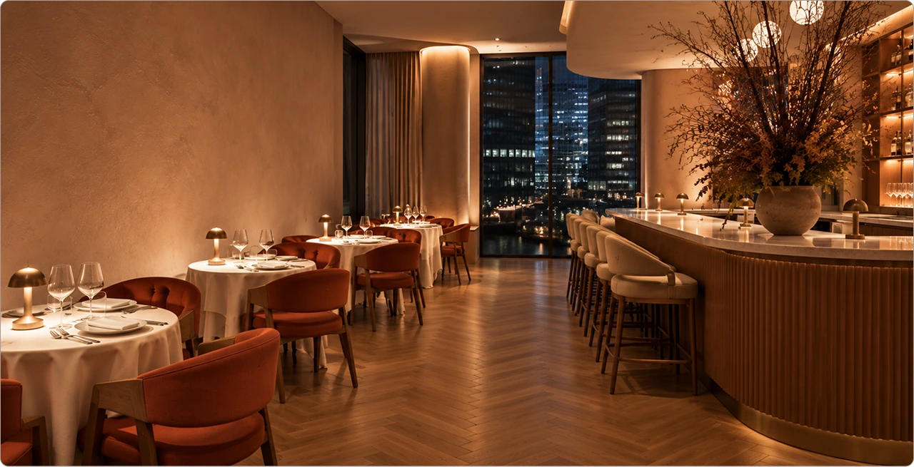 Wide view of Netrisok’s dining room with set tables and a curved bar